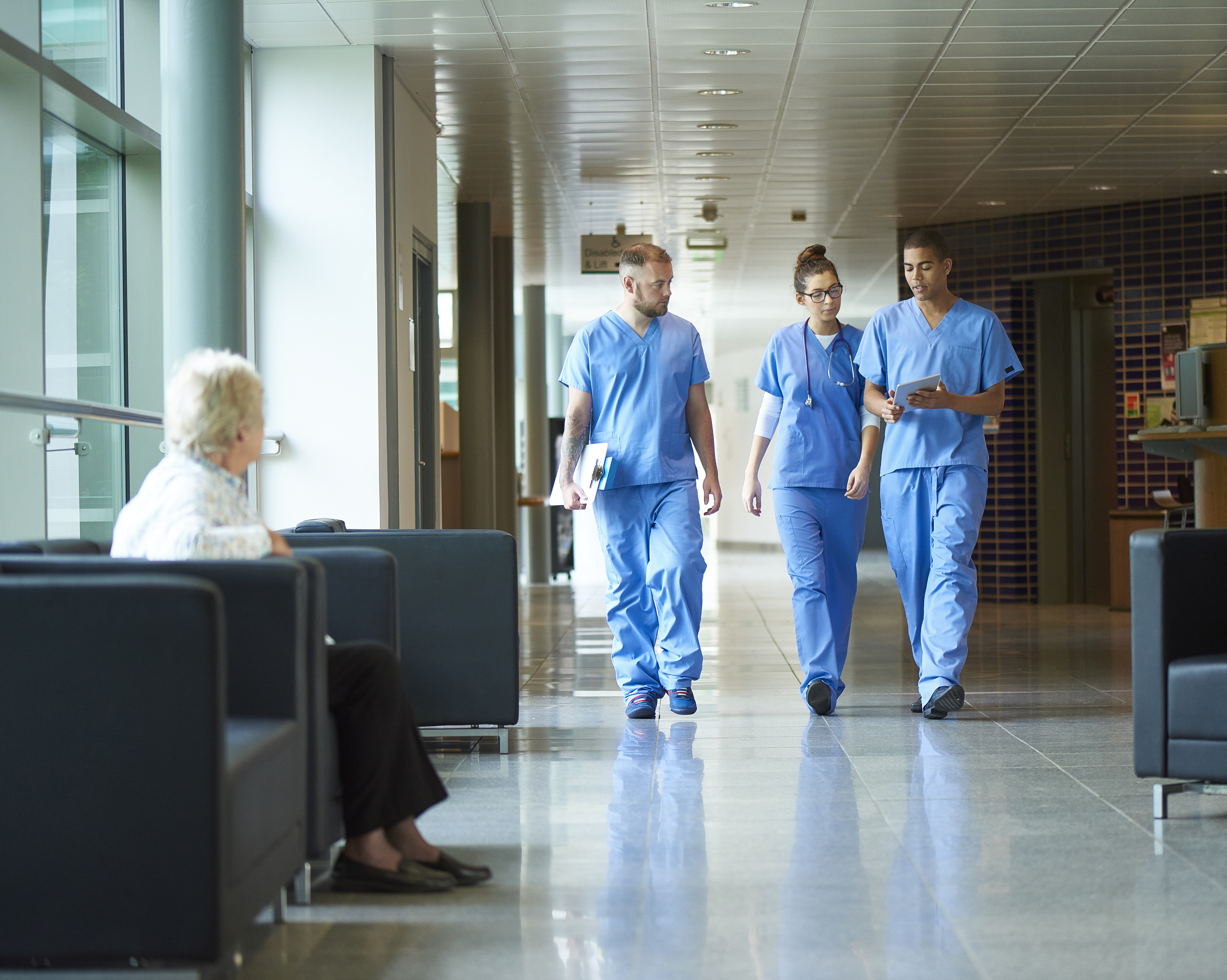 Group of Doctors walking down a hospital corridor.